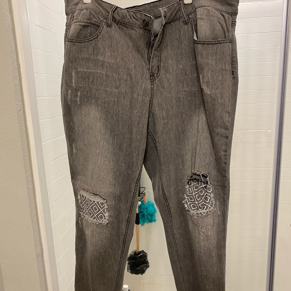 Grey jeans with rips and patches